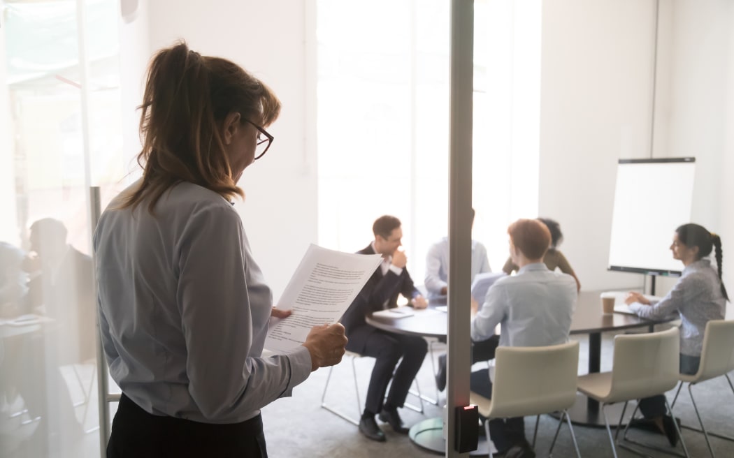 Stressed nervous stuttering inexperienced businesswoman standing at office door feeling afraid worried before performance reading paper preparing business speech, public speaking fear anxiety concept