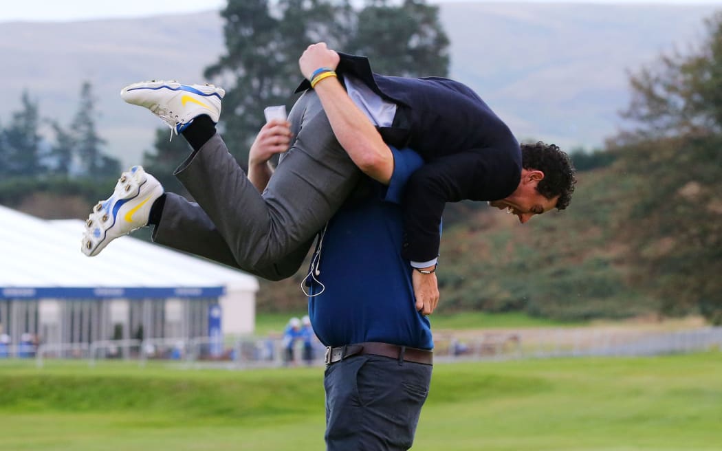 Europe's Rory McIlroy celebrates with a European Tour official. Ryder Cup. 2014.