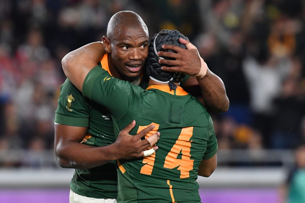 South Africa's wing Makazole Mapimpi is congratulated by South Africa's wing Cheslin Kolbe after scoring his try during the 2019 Rugby World Cup final.