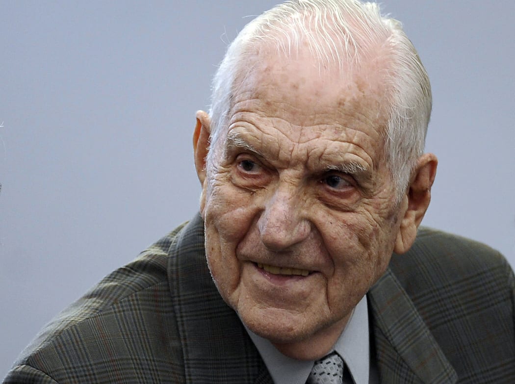 Last Argentine dictator (1982-1983) and Army chief Reynaldo Bignone smiles at the courtroom before being sentenced during his trial, in Munro, Buenos Aires on April 20, 2010.