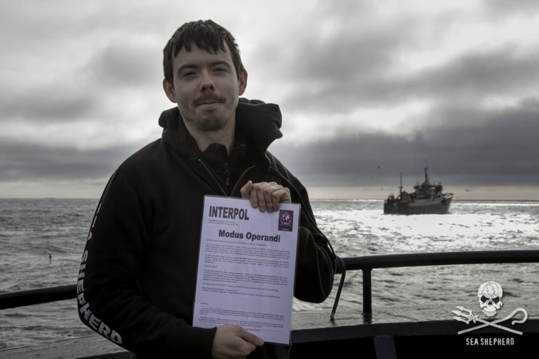 Sea Shepherd captain Peter Hammarstedt holding an Interpol notice for the 'Thunder'.