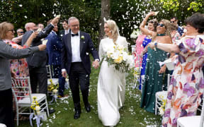 Australia’s Prime Minister Anthony Albanese (L) and his new wife Jodie Haydon walk together during their wedding ceremony in Canberra on November 29, 2025. (Photo by MIKE BOWERS / AFP) / -- IMAGE RESTRICTED TO EDITORIAL USE - STRICTLY NO COMMERCIAL USE --