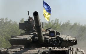 Ukrainian troops ride a tank on a road of the eastern Ukrainian region of Donbas on 21 June, 2022, as Ukraine says Russian shelling has caused 'catastrophic destruction' in the eastern industrial city of Lysychansk, which lies just across a river from Severodonetsk where Russian and Ukrainian troops have been locked in battle for weeks.