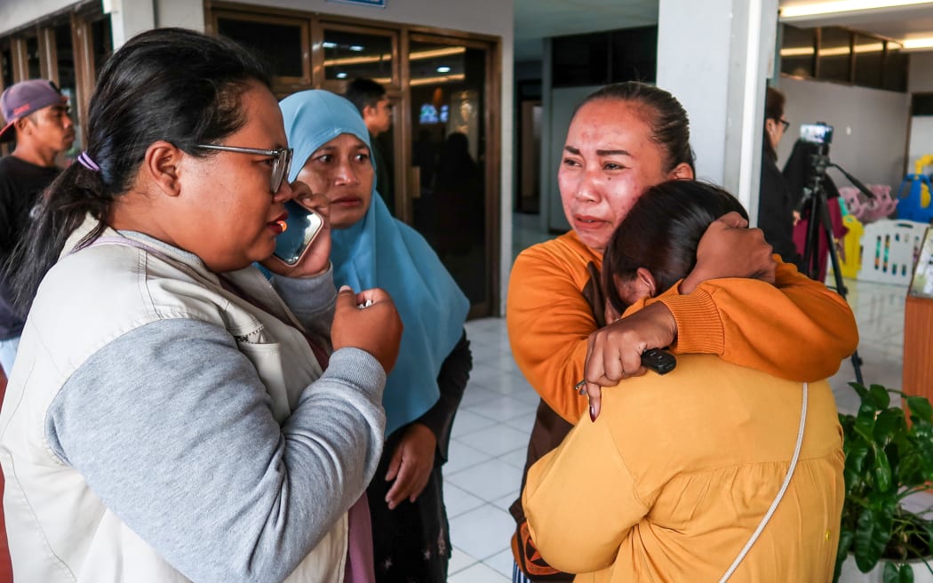 Family members and relatives wait for updates on the search operation of at least 61 people who were missing after a ferry sank off the popular Indonesian resort island of Bali, at Ketapang Port in Banyuwangi, East Java on July 3, 2025. (Photo by AFP)