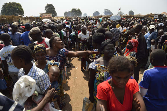 Displaced people wait for food to be distributed near a makeshift camp next to Mpoko Bangui airport.