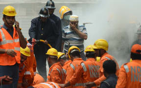 A 117-year-old condemned building has collapsed in the Indian city of Mumbai after torrential rains this week, killing at least 22 people, with about 10 others feared trapped, police and fire officials say.