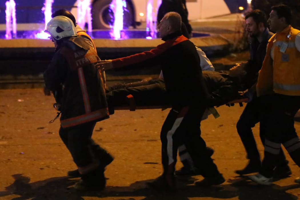 Police carry away one of the injured after a deadly explosion in the Turkish capital on 14 March 2016 (NZT).