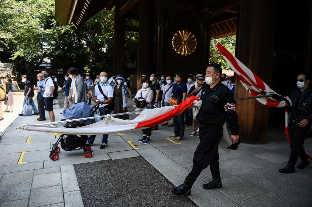 Members of a far right group parade inside the Yasukuni shrine in Tokyo on August 15.