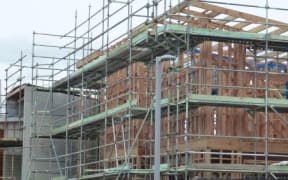 House being built surrounded by scaffolding