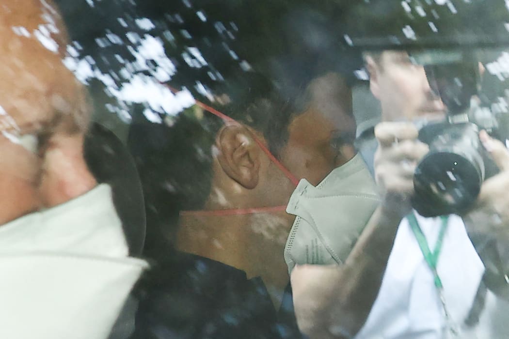 Novak Djokovic wears a face mask as he arrives at the lawyer's office in Melbourne on 16 January 2022.