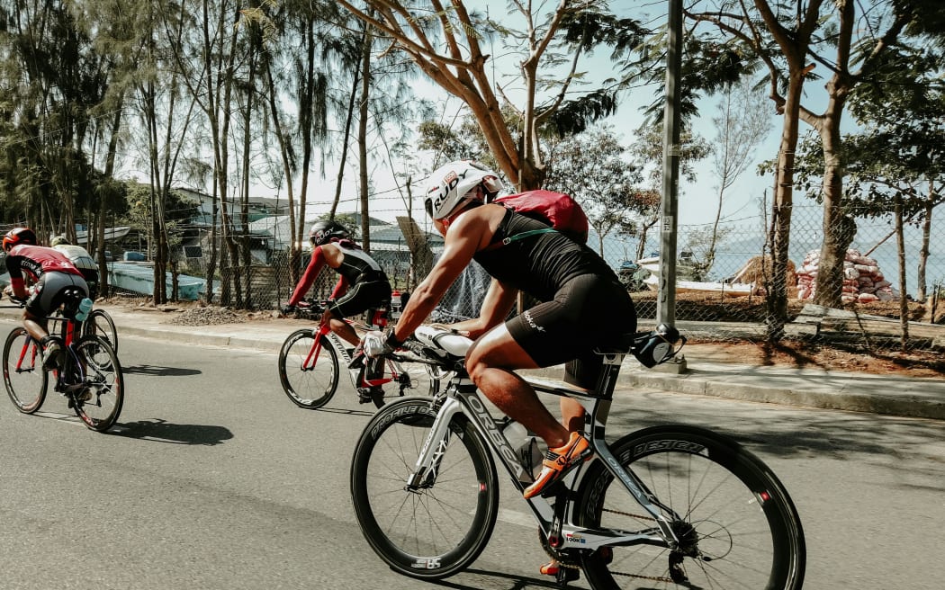 People cycling on a road.