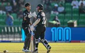 New Zealand's Rachin Ravindra (L) celebrates with teammate Kane Williamson after scoring a century at the Champions Trophy, 2025.
