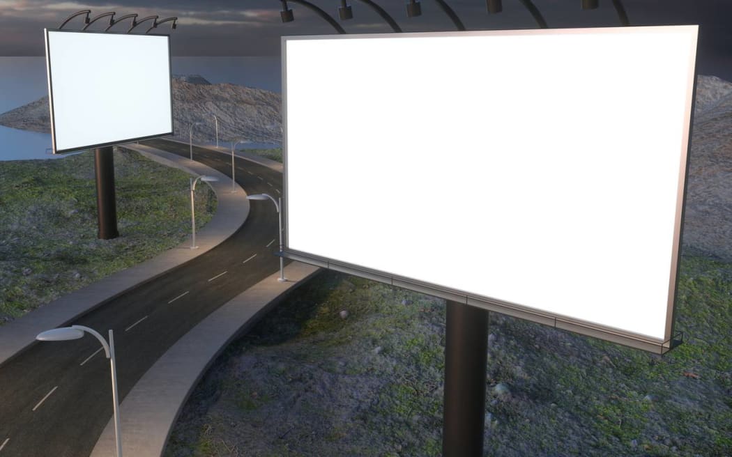 Two digital billboards on a highway.