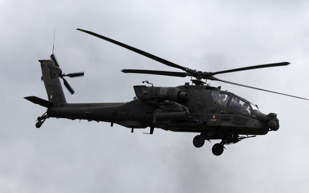 A US Army AH-64D Apache helicopter hovers flies during military exercises of Poland and NATO allied countries in Orzysz, northwestern Poland, on September 17, 2025. (Photo by Wojtek RADWANSKI / AFP)