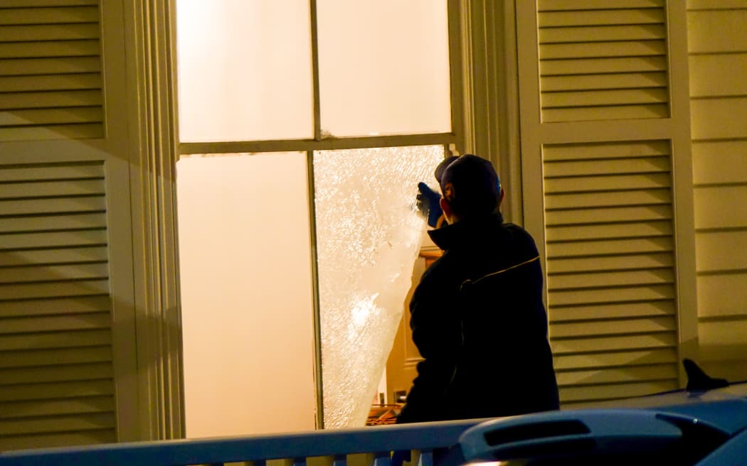 A glazier repairs a broken window at the Auckland home of Winston Peters.