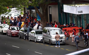 A crowd gathers outside City Mission in central Auckland, waiting for the special Christmas parcels.