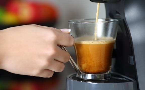 Close up of a woman hand using a coffee maker