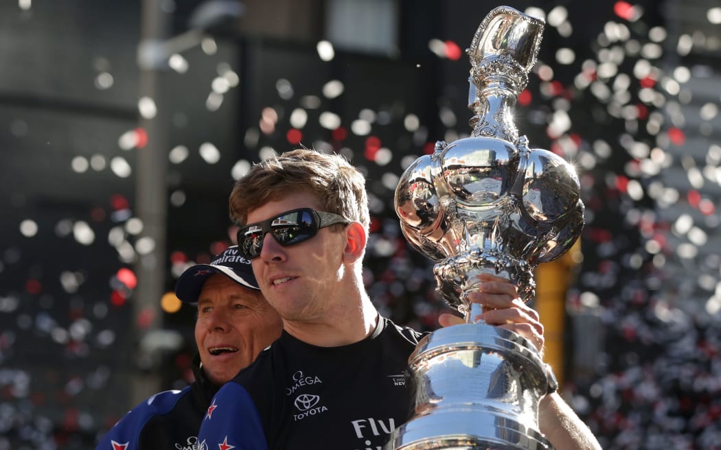 Peter Burling with cup and ticker tape in Wellington