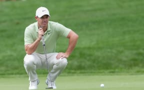 Rory McIlroy lines up a putt.