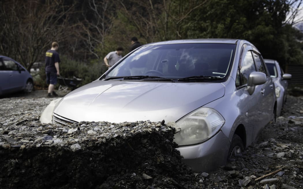 Cars buried by slip debris in Reavers Lane, Queenstown.