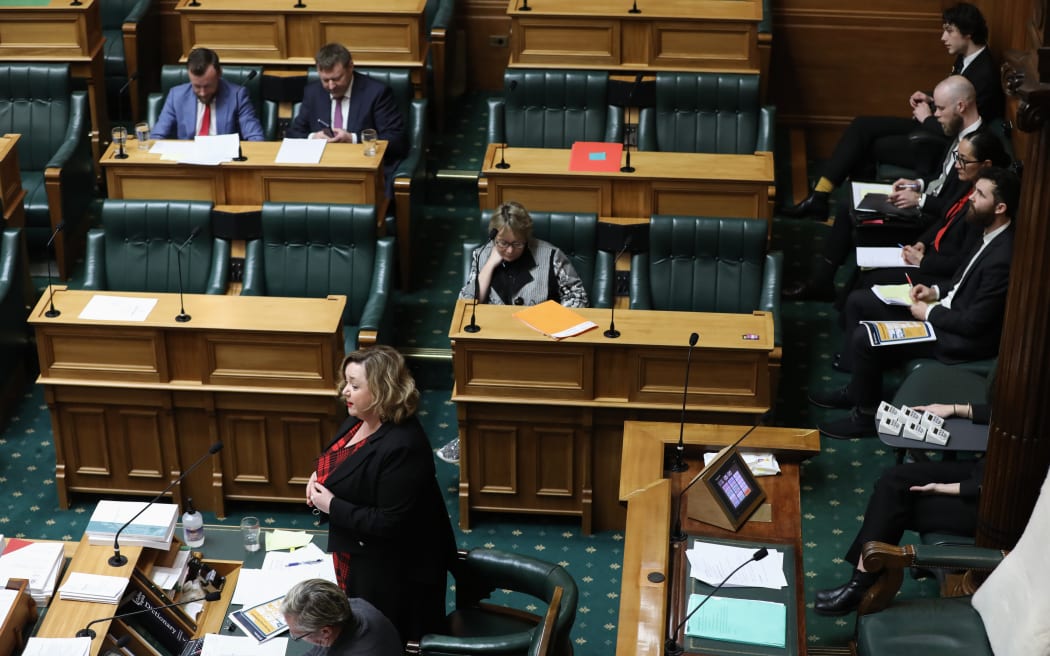 Megan Woods answers MPs Estimates questions from the Table while ministry officials line up (top right) available to provide further information