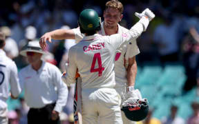 Australia’s Cameron Green (R) and teammate Alex Carey celebrate after hitting the winning runs on day five of the fifth Ashes cricket Test match between Australia and England at the SCG in Sydney on January 8, 2026. (Photo by DAVID GRAY / AFP) / -- IMAGE RESTRICTED TO EDITORIAL USE - STRICTLY NO COMMERCIAL USE --