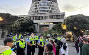 Police and protesters at Parliament on 21 February 2022.