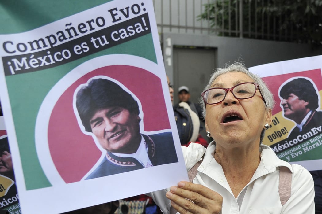 People demonstrate in support of Bolivian ex-President Evo Morales in front of the Bolivian embassy in Mexico City.