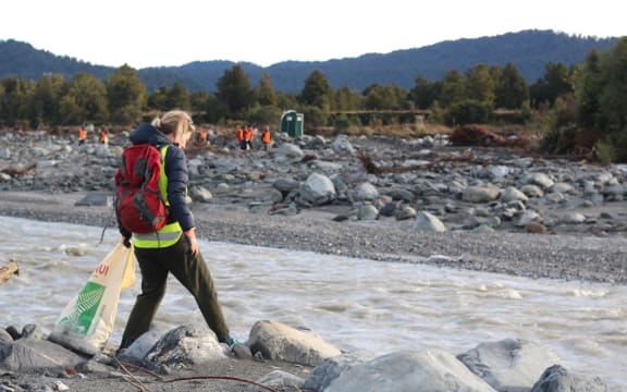 Volunteers pick up rubbish where a disused Fox River landfill spilled litter on the West Coast.