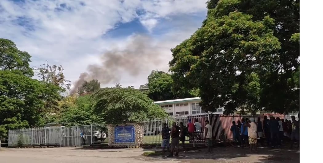 Smoke rising from a hut in the Solomon Islands parliament grounds after the protests.
