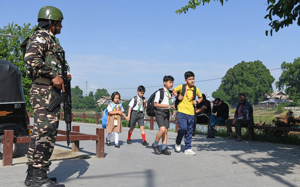 Schoolchildren walk to school in Srinagar on May 13, 2025, as schools reopen following the India-Pakistan ceasefire. (Photo by Basit Zargar / Middle east images / Middle East Images via AFP)