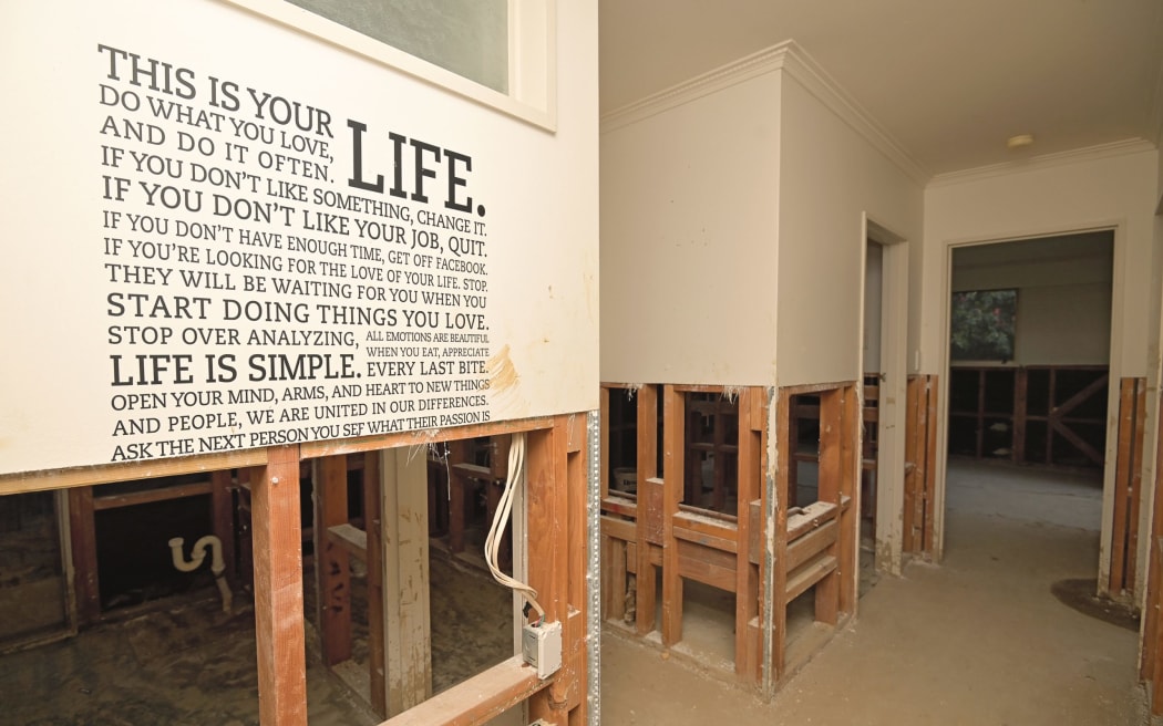 A quote at the end of the hallway is one of the few things left in the Vogel Street house. Built in the 1970s with concrete walls, it is too heavy to be lifted off site.