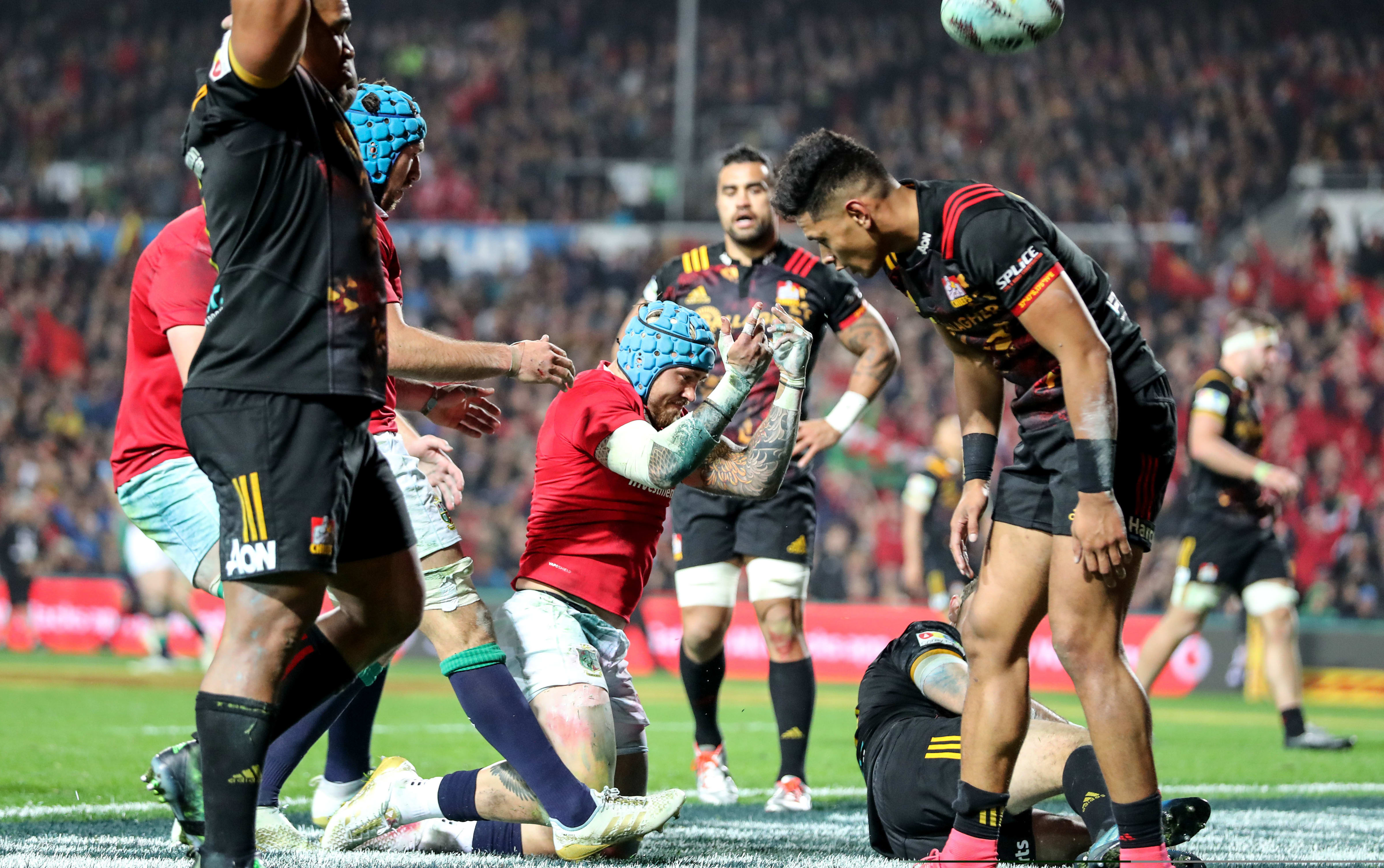 Lions player Jack Nowell celebrates scoring their third try as Chiefs players gather themselves.