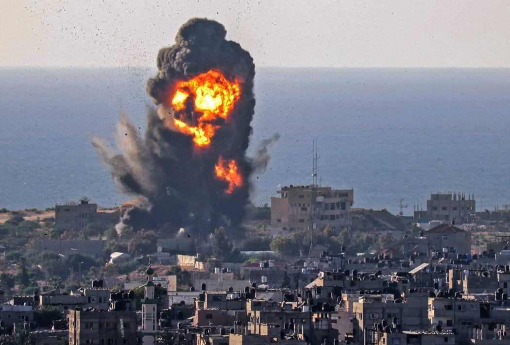 Smoke billows from an explosion following an Israeli air strike in Rafah in the southern Gaza Strip on 13 May 2021.
