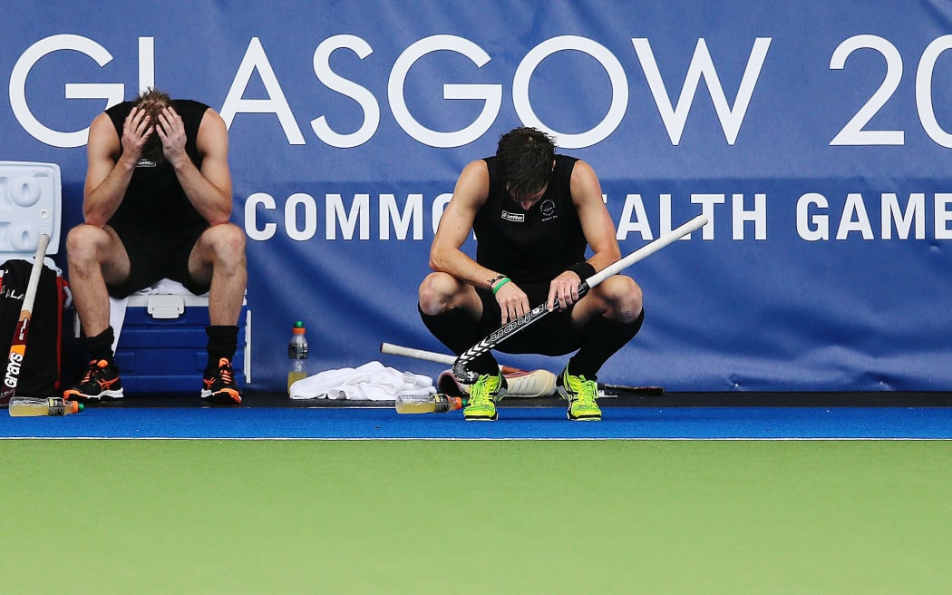 Dean Couzins (L) and Simon Child of New Zealand dejected after losing the bronze medal match.