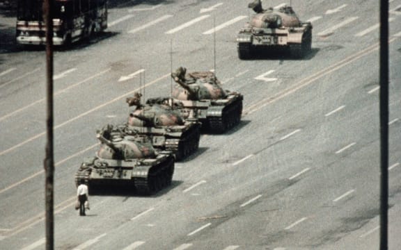 A Beijing demonstrator blocks the path of a tank convoy along the Avenue of Eternal Peace near Tiananmen Square. For weeks, people have been protesting for freedom of speech and of press from the Chinese government.