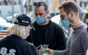 Attendees present their "green passes" (proof of being fully vaccinated against COVID-19 coronavirus disease) as they arrive at Bloomfield Stadium in the Israeli Mediterranean coastal city of Tel Aviv on March 5, 2021,
