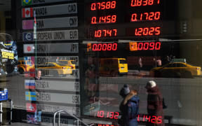 Foreign exchange rates displayed in a bank window.