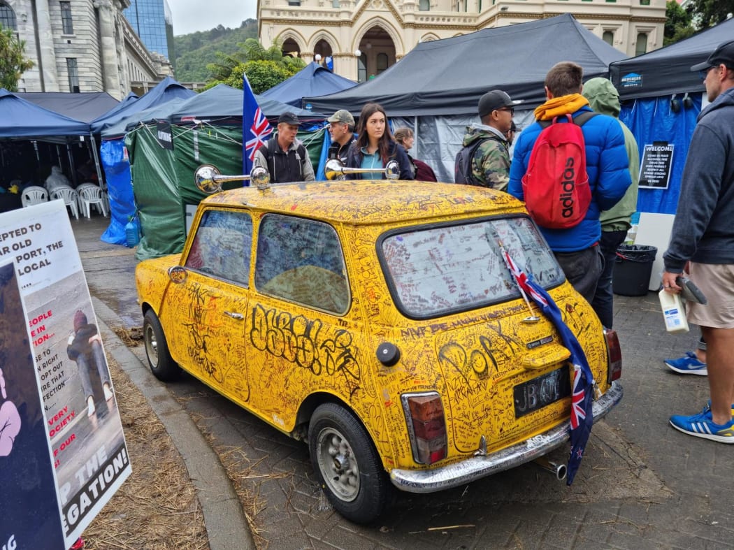 A graffiti covered car parked at the protest camp at Parliament.