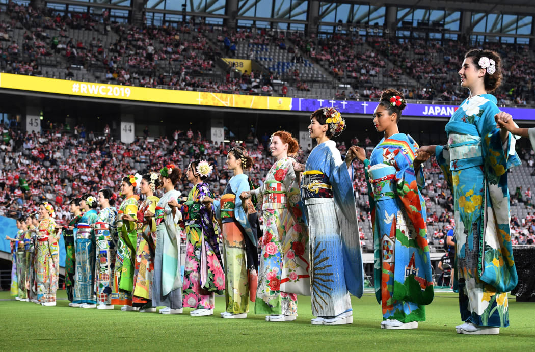 Performers in kimonos stand on the pitch of the Tokyo Stadium in Tokyo ahead of the Pool A opening match of the Japan 2019 Rugby World Cup between Japan and Russia on September 20, 2019. (Photo by Toshifumi KITAMURA / AFP)