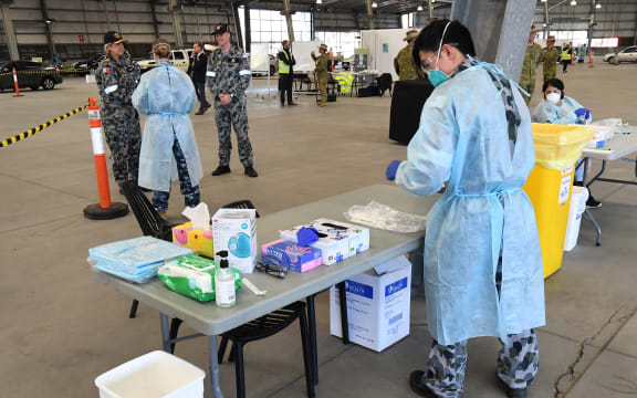 Surgeon General of the Australian Defence Force, Rear Admiral Sarah Sharkey (L), speaks to defence personnel manning a Covid-19 coronavirus drive-through testing station in Melbourne on June 29, 2020. The city has seen a resurgence in the virus.