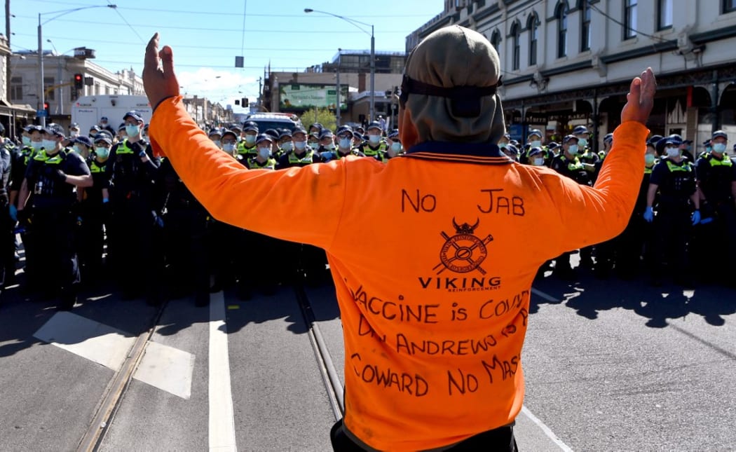 A protester confronts the police during an anti-lockdown rally in Melbourne on 18 September, 2021.