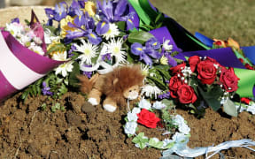 AUCKLAND, NEW ZEALAND - JUNE 24:  Flowers and toys lie on the grave for twin baby boys Chris and Cru Kahui (Photo by Jeff Brass/Getty Images)