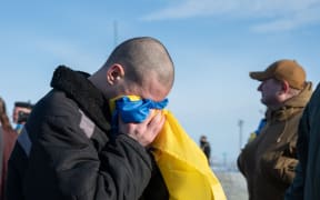 One Ukrainian soldier was seen kissing the country's national flag after the reported prisoner exchange.