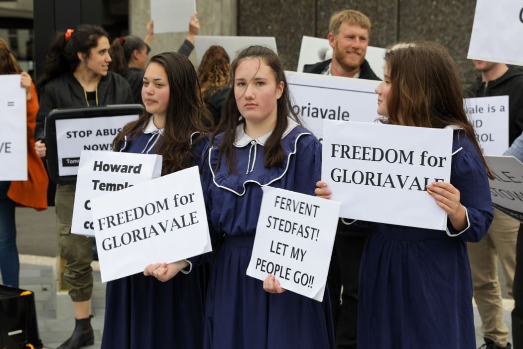 Children join a protest calling for a government inquiry into Gloriavale