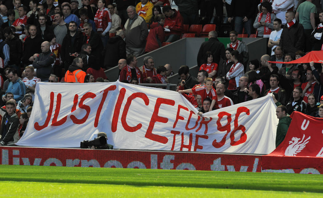 File photo of Liverpool supporters holding a banner in memory of the 96 who died during the Hillsborough disaster.