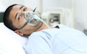 Patient in the hospital with oxygen mask (stock photo)