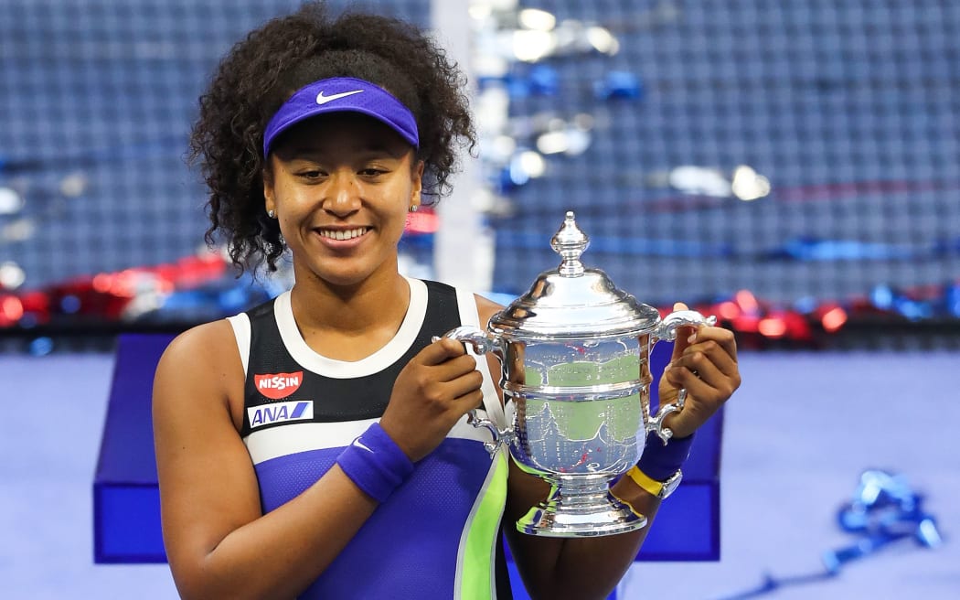 NEW YORK, NEW YORK - SEPTEMBER 12: Naomi Osaka of Japan celebrates with the trophy after winning her Women's Singles final match against Victoria Azarenka of Belarus