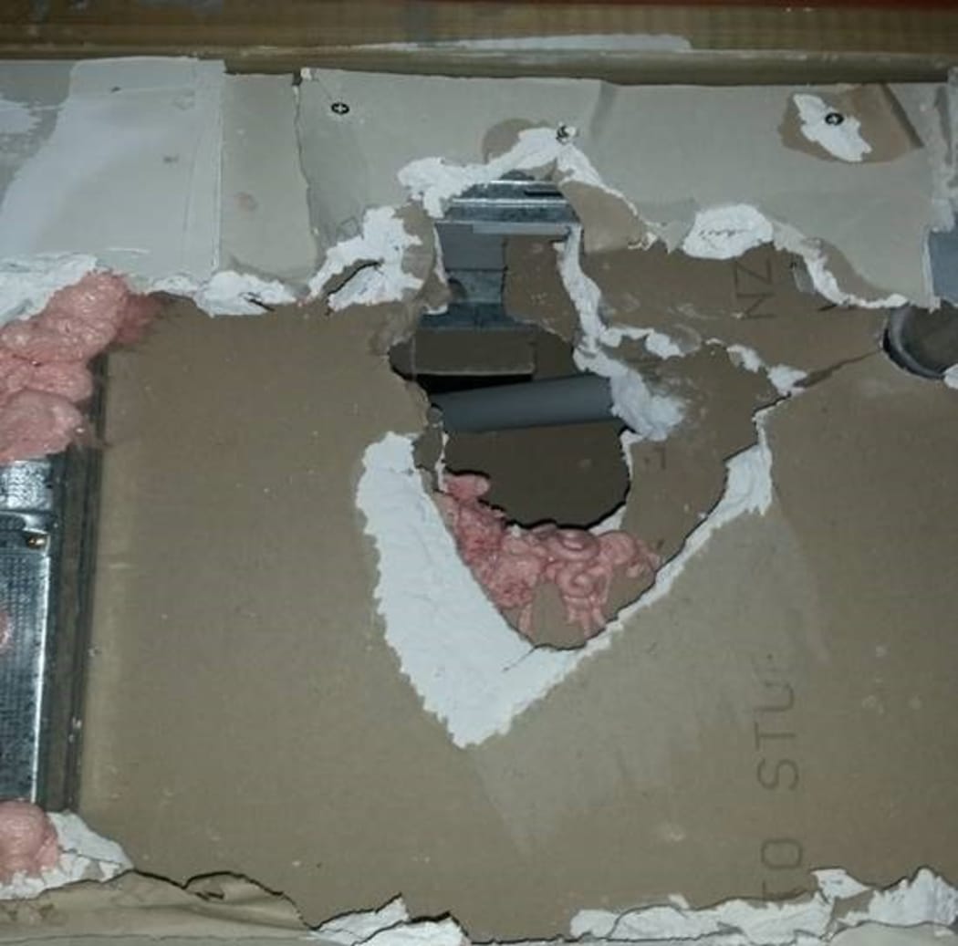 A photo of poor fire rating work that would let smoke and flames through.