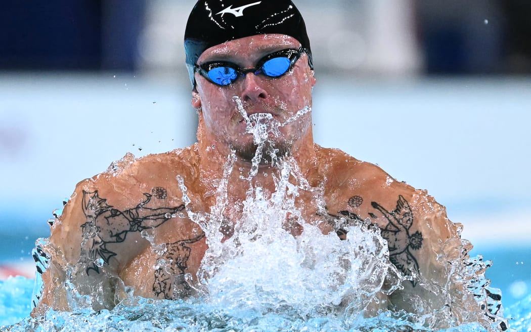 Individual Neutral Athlete Evgenii Somov competes in   a heat of the men's 100m breaststroke swimming event at the Paris 2024 Olympic Games at the Paris La Defense Arena in Nanterre, west of Paris, on July 27, 2024. (Photo by Jonathan NACKSTRAND / AFP)